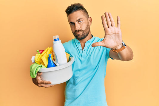 Man with bowl of cleaning and sanitising products